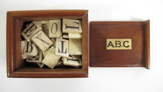 49 various bone letter counters and 2 paper ditto contained in a rectangular wooden box