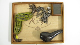 A carved Meerschaum and amber cheroot holder in the form of a  claw, a child's spinning top and a smal collection of curios