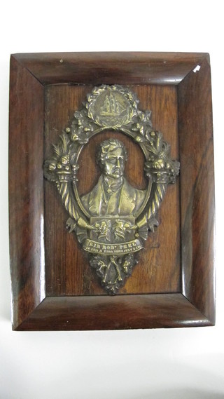 A gilt metal plaque depicting Sir Robert Peel, contained in a rosewood frame 9" x 7"