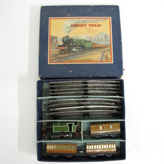 A Hornby O gauge clockwork train set comprising tank engine, 4  carriages and rails, boxed