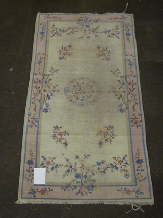 A 1930's white ground and floral patterned Chinese rug 77" x  37", heavily worn