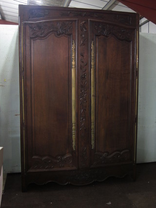 A French carved elm armoire with cornice enclosed by a panelled door 58"