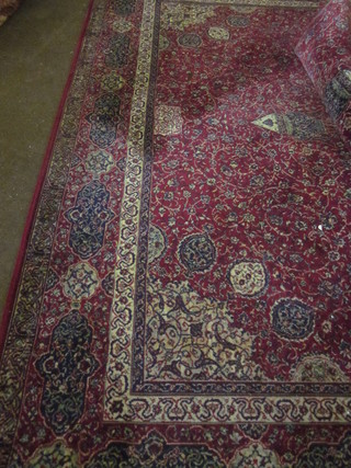 A red ground Persian style Wilton carpet with central medallion  143" x 109", two 8" cuts to the side,