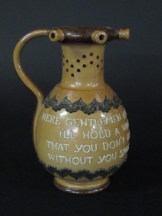 A Royal Doulton salt glazed puzzle jug with motto, the base  incised Doulton 9"