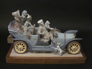 A Lladro limited edition figure group "Familiar Rallye" in the  form of a vintage car with figures therein, 22 1/2", 1 passenger's  foot f,