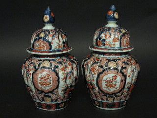 A pair of 19th Century Japanese Imari urns and covers with lobed borders 12", 1 finial f and r,  ILLUSTRATED