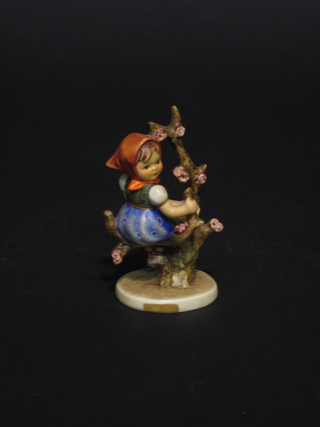A Hummel figure of a girl sat by a tree 4"