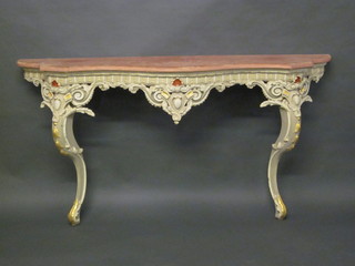A painted wood and pierced plaster console table of serpentine outline, raised on cabriole supports 63"