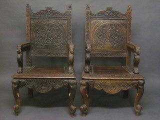 A pair of Eastern carved hardwood throne chairs, raised on  elephant supports