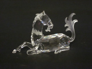 A Swarovski crystal figure of a seated Unicorn, horn missing, 5"