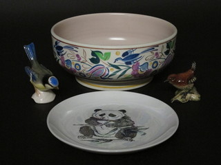 A Poole Pottery circular bowl with floral decoration, the base with dolphin mark and incised 682 9", a Poole Pottery plate  decorated a Panda 6", a Goebel figure of a Bluetit and a Beswick  figure of a Wren