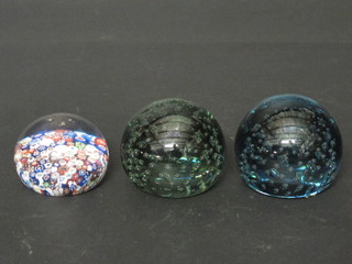 2 circular bubble glass paperweights 3" and 1 other