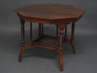 An Edwardian octagonal walnut occasional table with square  undertier raised on spiral turned supports 35"