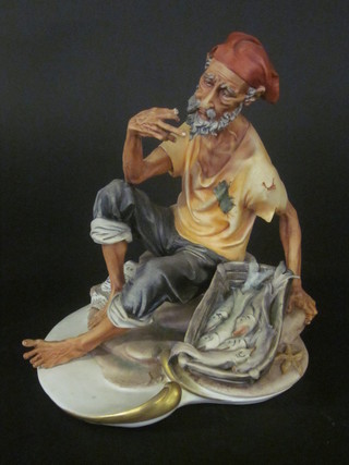 A Capo di Monte figure of a seated fisherman 10"