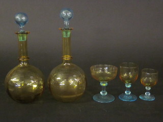 A suite of 14 amber coloured glasses comprising pair of club shaped decanters and stoppers and 12 various glasses