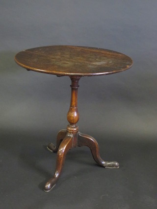 A Georgian circular oak snap top wine table, raised on a pillar  and tripod base 25 1/2"