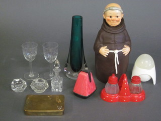 A pottery decanter in the form of a standing monk and a small collection of glassware