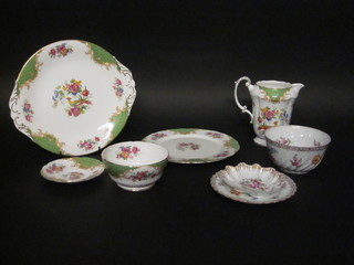 A Paragon Rockingham pattern 46 piece tea service comprising circular twin handled plate, 6 tea plates 8 1/2", 7 side plates 6",  jug 5 1/2", 6 large cups and 6 large saucers, 5 cracked, 7 coffee  cans, 8 saucers, circular sugar bowl, a late Dresden cup and  saucer, do. sugar bowl, scallop shaped dish and 5 other plates