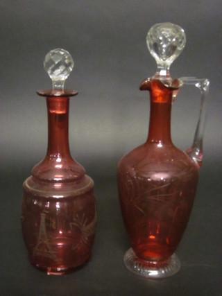 A 19th Century French etched red glass club shaped decanter decorated the Eiffel Tower marked 35th degree, 11", together  with a cranberry glass ewer and stopper with clear glass handle  13"