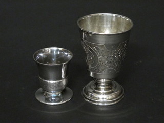 An engraved white metal goblet, the base marked 1867 84 and 1  other white metal shot glass
