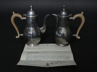 A Queen Anne style silver coffee pot and matching hotwater jug, London 1860, decorated the Cypher of Napoleon III, previously  the property of Empress Eugenie of France and last sold at  Farnborough Hill 25 July 1927, 22 1/2 ozs, complete with  various paper work  ILLUSTRATED