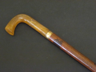 A Malacca cane with gilt band and horn handle
