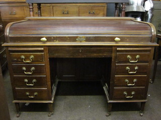 An Edwardian mahogany kneehole pedestal roll top desk, the  kneehole fitted a cupboard and the pedestals fitted 8 short  drawers, 53"