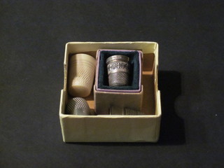 A silver thimble, an "ivory" thimble and 2 others