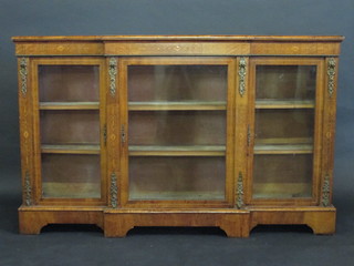 A Victorian inlaid walnut break front Credenza with gilt metal mounts, the interior fitted shelves with gilt metal mounts, raised  on a platform base 66"  ILLUSTRATED