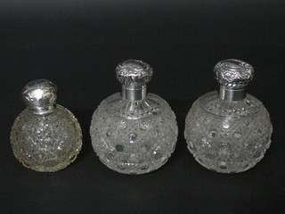 A pair of Victorian globular cut glass scent bottles with hinged lid, both f, Birmingham 1896, 3" and 1 other cut glass dressing  table jar