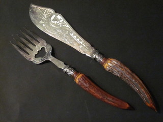 A pair of engraved silver plated fish servers with stag horn handles