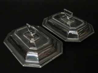 A pair of silver plated lozenge shaped entree dishes and covers