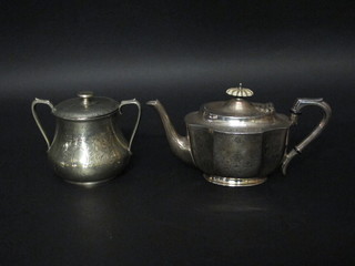 An oval Britannia metal teapot and a sugar bowl and cover