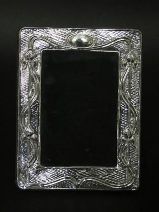 A modern Art Nouveau style embossed silver easel photograph  frame 7 1/2" x 5 1/2"