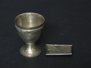 An Edwardian silver stamp case in the form of an envelope, Birmingham 1903 and a silver egg cup