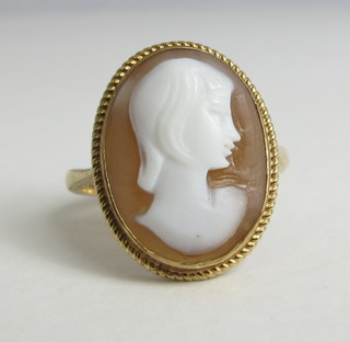A gold dress ring set a shell carved cameo portrait