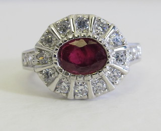 A lady's silver dress ring set an oval ruby with white sapphires to the shoulders, ruby approx 2.20ct