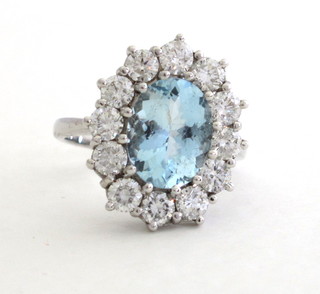 A lady's 18ct yellow gold dress ring set an oval aquamarine surrounded by diamonds approx 2.0/3.0ct