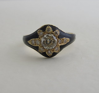 An 18ct gold and black enamelled dress ring set a diamond to the  centre supported by numerous diamonds