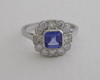 A lady's 18ct white gold dress ring set a square cut sapphire  surrounded by diamonds