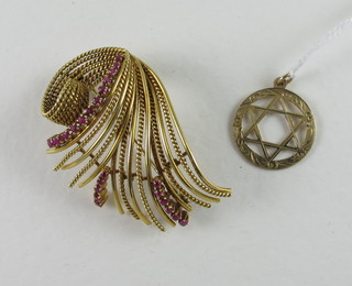 A "gold" spray brooch set rubies together with a shield of David pendant