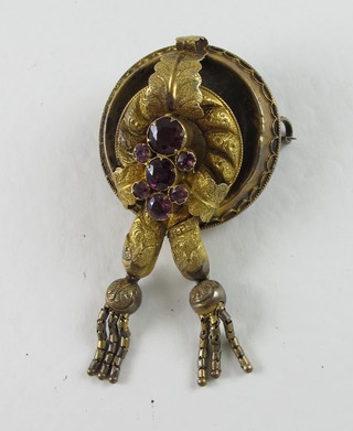 A Victorian pinchbeck brooch set amethyst coloured stones