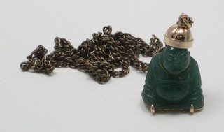 An Eastern green carved hardstone pendant hung on a gilt chain
