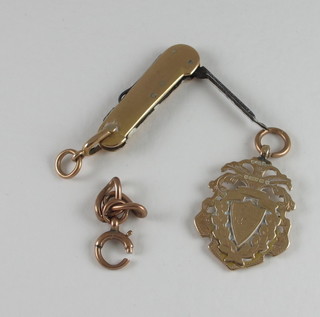 A gold watch chain medallion, a small chain medallion, a small section of 9ct gold curb link chain and a gilt cased folding pen  knife