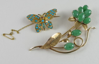 A gilt metal floral brooch set green hardstones together with a  gilt metal brooch in the form of a butterfly set turquoise