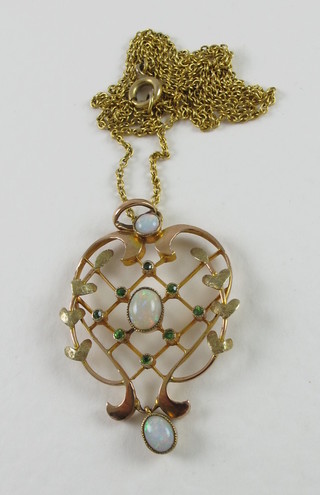 A 9ct pierced gold pendant set emeralds and opals hung on a fine gold chain