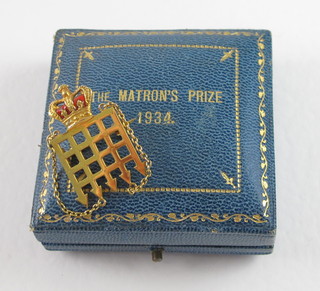 A 9ct gold and enamelled bar brooch in the form of a port cullis,  The Matron's Prize 1934 for Westminster Hospital, the reverse  marked Edith Freda Davies