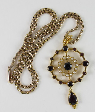 An 18ct pierced gold pendant set red stones and pearls hung on a box link chain