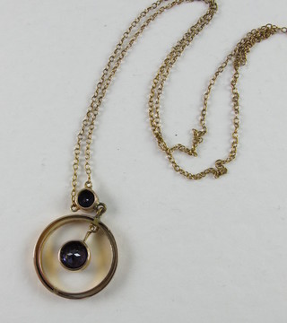 A gold pendant set an aquamarine hung on a fine gold chain