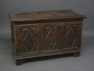 An 18th Century oak coffer of panelled construction with hinged lid 41"